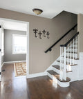Decorative wall mount key hooks set of four in dark brown, cast iron, featuring Fleur De Lis charm in a spacious entryway.