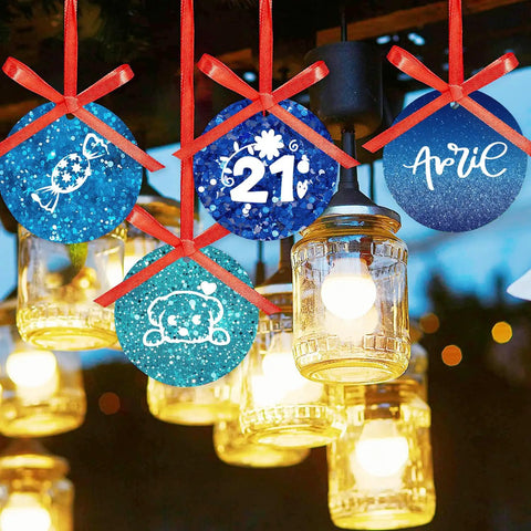 Blue Glitter Sublimation Transfer Sheets For Tumblers And Tees 12x12 Inches 10 Pack hanging with festive designs.