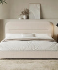 Queen Size Cloud Bed Frame In Beige Plush Boucle Upholstery with soft pillows and bedside lamp in modern bedroom.
