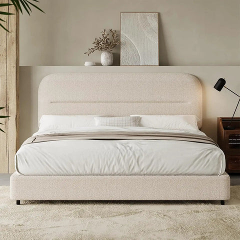 Queen Size Cloud Bed Frame In Beige Plush Boucle Upholstery with soft pillows and bedside lamp in modern bedroom.
