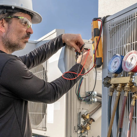 Technician using Magnetic Multimeter Hanging Strap Kit With Dual Magnet Loop And Clip for hands-free testing on HVAC system