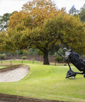 All Terrain Remote Controlled Electric Golf Caddy With Quick Zip Fold Setup Includes Drink Phone Umbrella Mounts Signature Power Bundle And Towel Keep It Smooth And Easy On The Daily on a golf course.