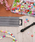Multi-colored beads, a pin vise, and Mini Micro Drill Bit Set 0.3-1.6 mm with case for jewelry-making projects.