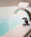 Score Instant Hot Water With This Beast-Mode 26.9 KW Electric Tankless Water Heater Engineered For Full Whole-House Flow With Zero Fuss Super Easy Install For Any Gig 3Phase 240V Power Gets You Streaming Hot Water Fast Reliable Goods For Home Or Business, showing a modern faucet with water flowing into a bathtub.