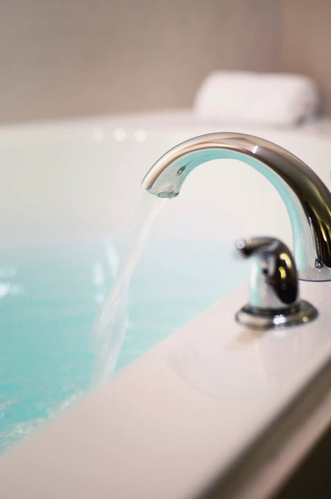 Score Instant Hot Water With This Beast-Mode 26.9 KW Electric Tankless Water Heater Engineered For Full Whole-House Flow With Zero Fuss Super Easy Install For Any Gig 3Phase 240V Power Gets You Streaming Hot Water Fast Reliable Goods For Home Or Business, showing a modern faucet with water flowing into a bathtub.