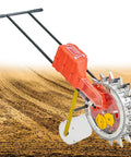 Garden Push Seeder Hand Push Manual Seeder With 16 Nozzles on soil with visible planting furrows