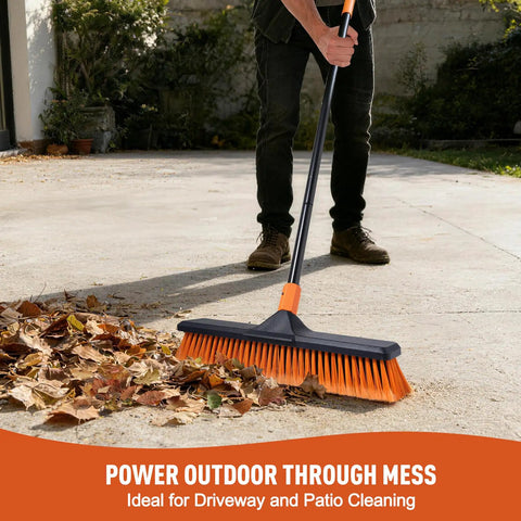 Person using 18 Inch Push Broom Outdoor Heavy Duty Beast for garages, driveways, and decks with durable iron handle on concrete surface