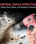 Powerful Cordless Air Duster In Pink With Rechargeable 8000mAh Battery In Action Blasting Dust From Surface