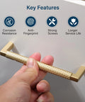 Close-up of hand holding 10 Pack Solid Zinc Alloy 5 Inch Center To Center Slim Square Bar Cabinet And Drawer Handles Gold Knurled Dresser Pulls
