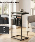 C Shaped End Table With Sliding Tray Under Sofa 28 Inch High Side Table With Storage Bag Black next to a gray sofa in a living room