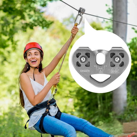 Double Zip Line Pulley Trolley With Tandem Dual Speed Pulleys 30kN 6700LBS Break Strength in a zip line setting with a person riding.