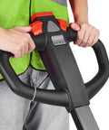 Massive 4400 Lb Electric Pallet Jack Truck With Lithium Battery And 48 Inch Forks For Heavy Material Handling In Warehouses And Supermarkets Plus Easy Ramp Climbing Power. Operator holding the control handle.