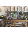Workshop with E-Track system holding various tools and baskets, including a heavy duty cargo organization hook.