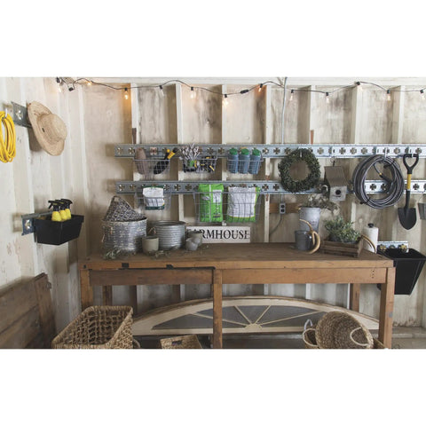 Workshop with E-Track system holding various tools and baskets, including a heavy duty cargo organization hook.