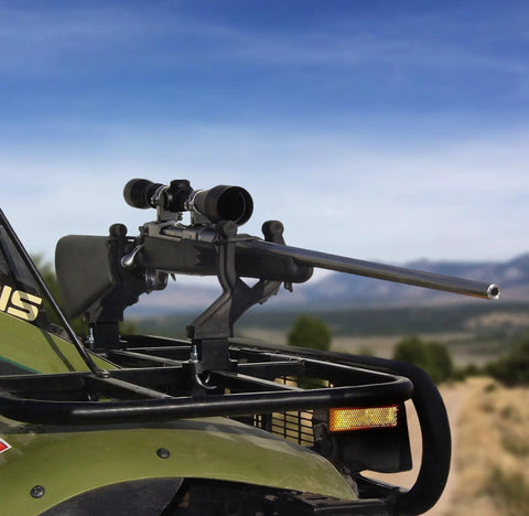 Rifle mounted on Single ATV Gun And Bow Rack For Handlebar Mounts, Fits Five Eighths To One Inch Tubular Bars, outdoors view