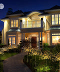 Solar Powered Firework Garden Lights 4 Pack With 120 LED Starburst String 8 Modes illuminating a house walkway at night