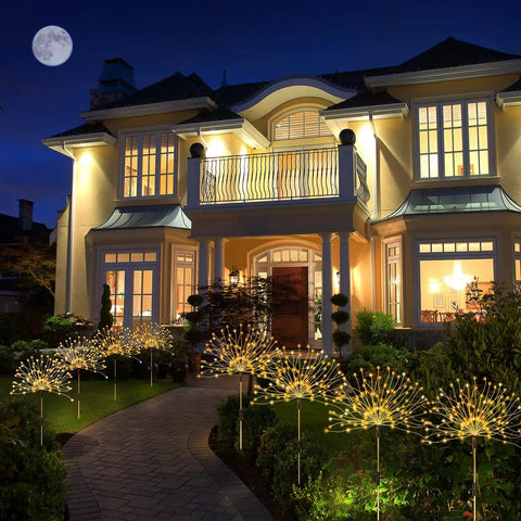 Solar Powered Firework Garden Lights 4 Pack With 120 LED Starburst String 8 Modes illuminating a house walkway at night