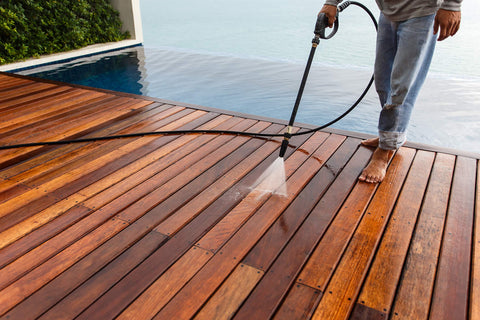 Person using Marine Penetrating Wood Sealer And Waterproofer With Stain For High Moisture Areas Water Based Ultra Low VOC Formula on deck