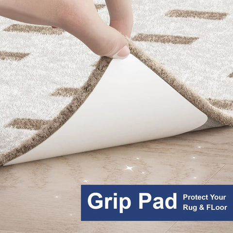 Hand lifting rug to reveal white 12 Pack Rug Tape Gripper For Hardwood Floors Double Sided Reusable Under Rug Tape Sticks Non Slip Rug Pads