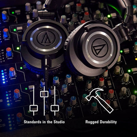 M50X Pro Studio Headphones With Detachable Cable Black resting on a mixing console in a dimly lit studio, highlighting durability.