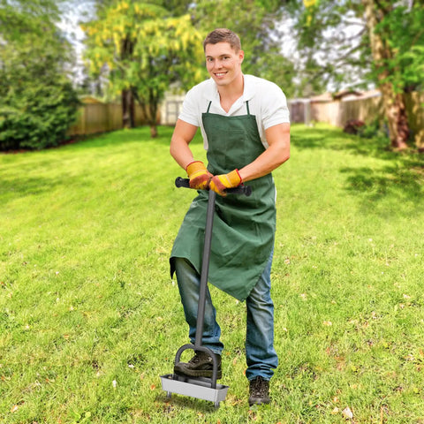 Person using Manual Lawn Core Aerator With Stainless Steel Core Plugs And Storage Tray on grass, wearing green apron and gloves.