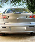 Rear view of a Mitsubishi Lancer Evolution X sedan with Dark Smoked Lens Full LED Trunk Lid Center Mount Third Brake Light Bar Assembly