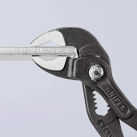 Cobra Pliers With One Handed Adjustment And Guard, gripping a metal piece, showcasing hardened teeth for strong grip, precision tasks