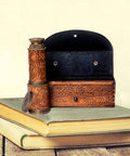 Old School Bronze Spyglass With Leather Case Seventeen Point Five Inch Brass Telescope, shown on books with case