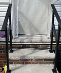 Heavy Duty Two Pack Galvanized Steel Handrails For Outdoor Steps Rust Resistant Black Round Safety Rails For Decks Patios, installed at concrete steps.