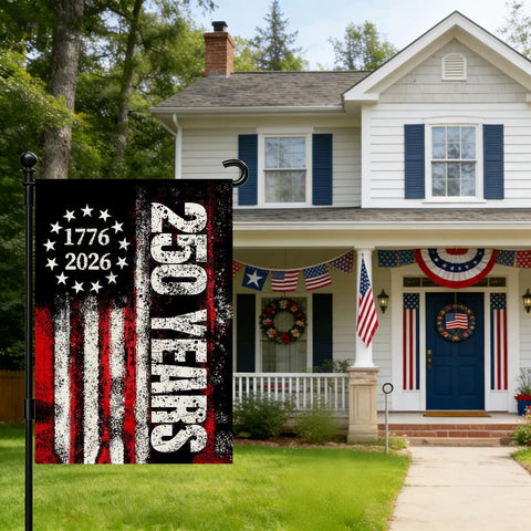 Patriotic 250th Anniversary USA Garden Flag displayed outside a house, showing stars and stripes with "250 Years" and "1776-2026" text.