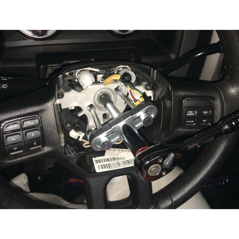Steering Wheel Remover Kit With SAE And Metric Bolts for 4 Inch Hubs and Late Model Puller Legs in use on car steering wheel