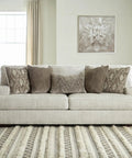 Living room with Magan 285 Textured Bronze Metal Table Lamp With Antique Brown Finish on a side table, next to a beige sofa.