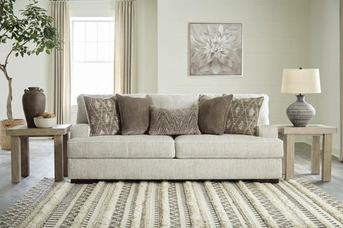Living room with Magan 285 Textured Bronze Metal Table Lamp With Antique Brown Finish on a side table, next to a beige sofa.