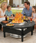 Family enjoying meal around Fire Pit Table Surround With 360 Degree Safety Barrier Built Tough In Heavy Duty Steel for campfire tables.