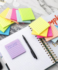 Lined Sticky Notes 3x3 Inches, 16 Pack With 56 Sheets Per Pad, 8 bright colors displayed on a planner and desk