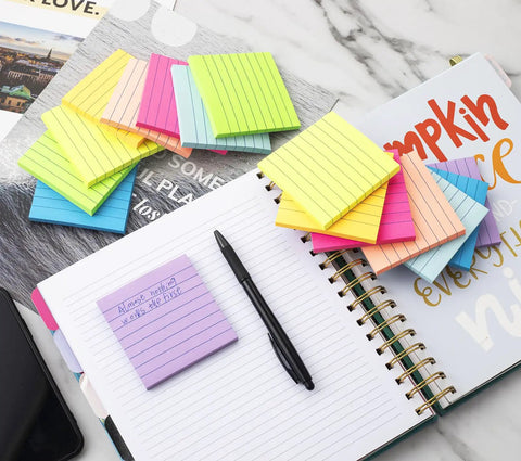 Lined Sticky Notes 3x3 Inches, 16 Pack With 56 Sheets Per Pad, 8 bright colors displayed on a planner and desk
