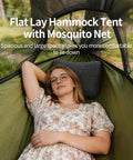 Relaxing in 3 In 1 Camping Hammock Tent With Mosquito Net And Rainfly, green fabric, woman lying comfortably outdoors