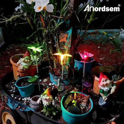 Solar Garden Lights Outdoor Set Of 6 Insect Stake Lights illuminating garden at night with colorful LED for butterflies and dragonflies.