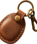 Premium Handmade Genuine Leather AirTag Holder And Keychain With Heavy Duty Rings Protective Case Compatible With Apple AirTags First And Second Gen Straight Up Solid Brown, close-up view of leather holder and keyring.