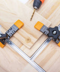 Heavy Duty T Track Hold Down Clamps Set No Fuss Quick Change Design For Woodworking in use on wooden boards with drill nearby
