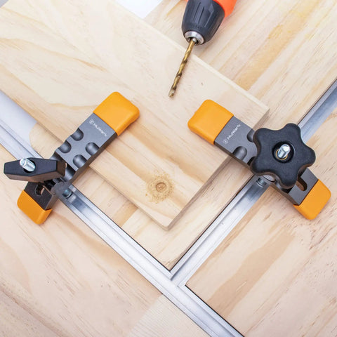 Heavy Duty T Track Hold Down Clamps Set No Fuss Quick Change Design For Woodworking in use on wooden boards with drill nearby