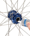 Applying HPG-1 High Performance Bicycle Grease 113 g to a bike hub for smooth, quiet ride, blue pro-grade lube for precision bearings.