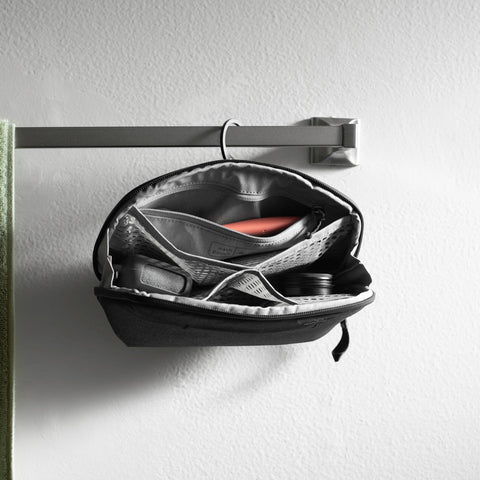 Small Wash Pouch Travel Toiletry Bag Weatherproof With Upright Or Hanging Design on towel rack, mesh pockets visible.