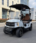 Kick Back In Comfort On This Sleek White Two Seater Electric Golf Cart Powered By A Dependable 48V Lithium Battery All Weather Dash Switches And Sure Grip Tires For Every Epic Course Round.