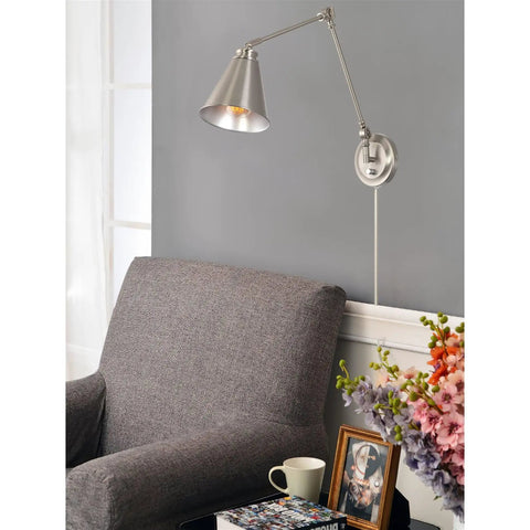 Dope Industrial 18 Inch Swing Arm Wall Lamp in Brushed Nickel above a gray armchair, floral decor, and a small table.
