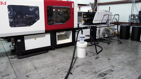 Heavy Duty Quick Click Dust Separator Featuring Slick Twelve Gallon Locking Collection Bin And Efficient Air Relief Design in a workshop.