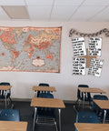 Classroom with desks, world map, and humorous signs including 'Its Low Key Sus When U Dont Show Ur Work Tin Sign' on wall.