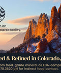 Food Grade Mineral Oil For Wood Cutting Boards And Butcher Blocks 16oz Safe For Bamboo Marble Soapstone And Stainless Steel Counters Made In USA Top Notch Kitchen Care And Conditioning For Long Lasting Finish, bottled in Colorado, USA with mountains in background.