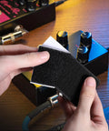 Hands applying Heavy Duty Guitar Pedalboard Mounting Tape With Adhesive Hook And Loop Strips Keeps Effects Pedals Secure On Your Board