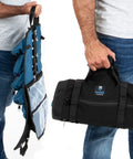 Two people holding Titan23XL Tool Roll And Organizer Bag With 23 Pockets, showing open blue interior and closed black exterior.